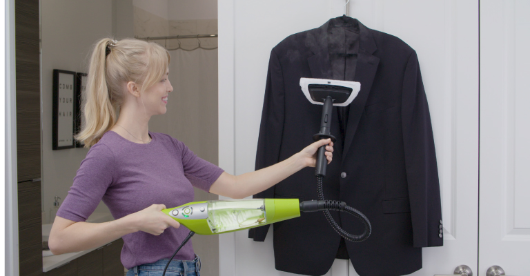 A lady steaming garments with H2O HD Handheld